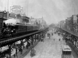 Elevated trains roll above busy streets in Manhattan's Bowery neighborhood, circa 1895.